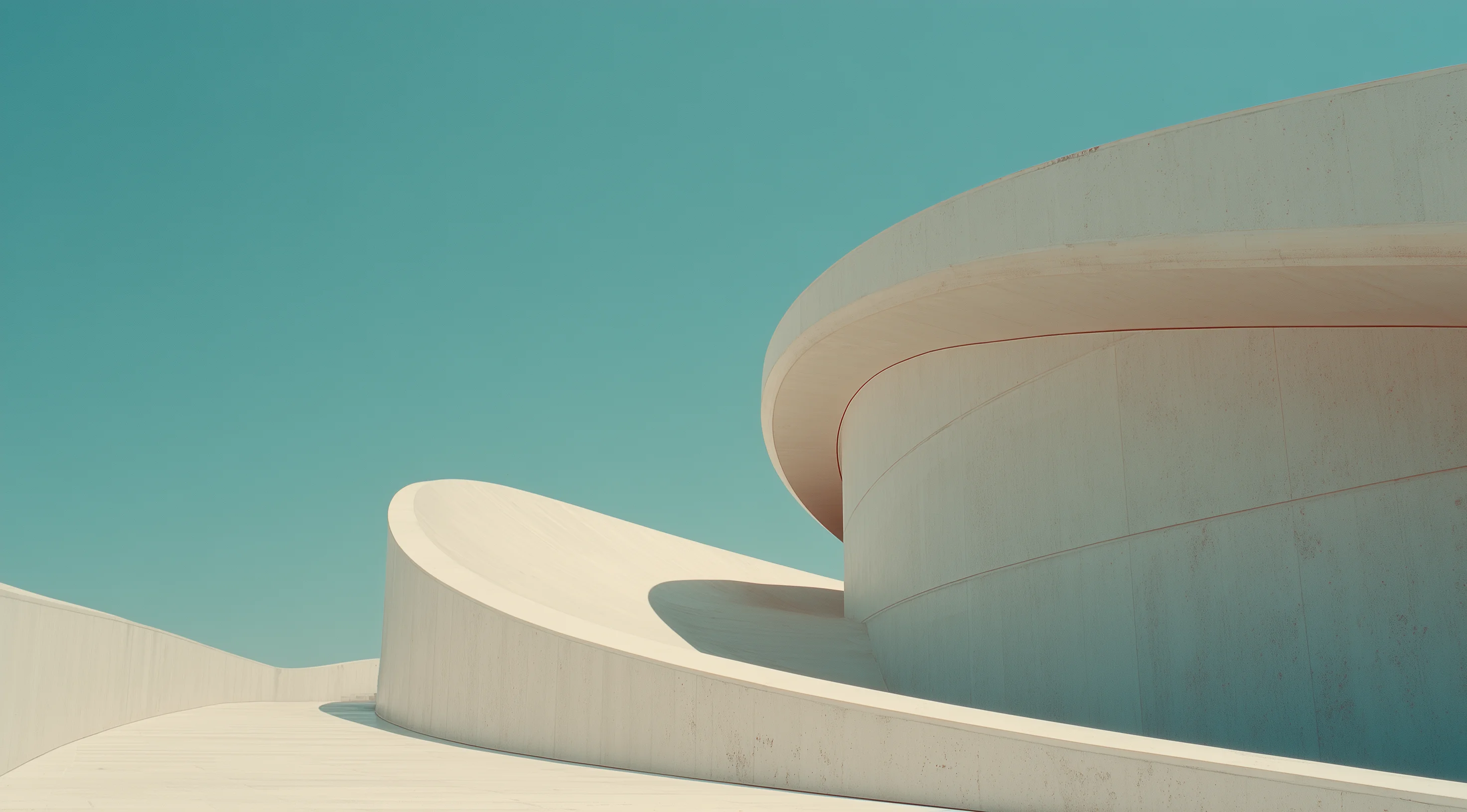 Curved white concrete architecture against a clear blue sky, showcasing smooth lines and modern design elements.